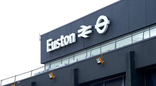 A white sign on a black background reading Euston from the Euston train station. A white sign on a black background reading Euston from the Euston train station.